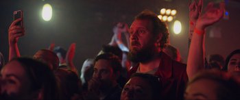 Movie still from “Yesterday” (2019), directed by Danny Boyle – A man with a long beard is watching a concert; Close Up shot, Low angle