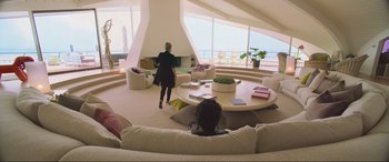 Movie still from “Yesterday” (2019), directed by Danny Boyle – A woman standing in front of a fireplace in a living room; Wide shot, High angle