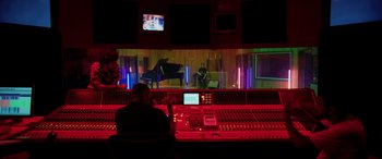 Movie still from “Yesterday” (2019), directed by Danny Boyle – A man sitting in front of a sound board in a recording studio; Wide shot, Over the shoulder angle