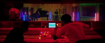 Movie still from “Yesterday” (2019), directed by Danny Boyle – A man sitting in front of a piano in a recording studio; Extreme Wide shot, Low angle