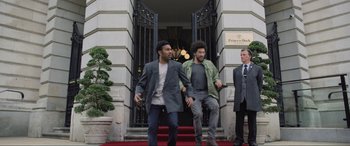 Movie still from “Yesterday” (2019), directed by Danny Boyle – Two men are walking down the steps of a building; Wide shot, Low angle