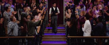 Movie still from “Yesterday” (2019), directed by Danny Boyle – A man walking down a set of stairs while holding a guitar; Wide shot, High angle