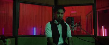 Movie still from “Yesterday” (2019), directed by Danny Boyle – A man sitting in front of a microphone in a recording studio; Medium shot, Low angle