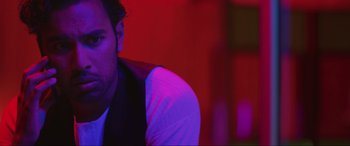 Movie still from “Yesterday” (2019), directed by Danny Boyle – A person wearing a white shirt and a black vest; Close Up shot, Over the shoulder angle