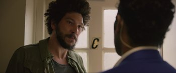 Movie still from “Yesterday” (2019), directed by Danny Boyle – A man with a beard looking into a mirror; Close Up shot, Over the shoulder angle