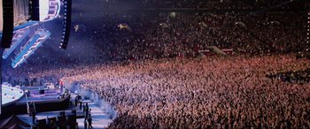 Movie still from “Yesterday” (2019), directed by Danny Boyle – A large crowd of people in a large stadium; Extreme Wide shot, High angle