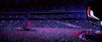 Movie still from “Yesterday” (2019), directed by Danny Boyle – A crowd of people in a stadium at night; Extreme Wide shot, High angle