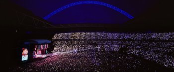 Movie still from “Yesterday” (2019), directed by Danny Boyle – A crowd of people in a stadium at night; Extreme Wide shot, High angle