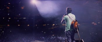 Movie still from “Yesterday” (2019), directed by Danny Boyle – A man standing in front of an audience at a concert; Wide shot, High angle