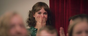 Movie still from “Yesterday” (2019), directed by Danny Boyle – A woman covering her mouth with her hands; Close Up shot, Over the shoulder angle