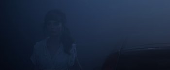 Movie still from “York Witches Society” (2022), directed by Liza Bolton – A woman standing in the middle of a foggy night; Medium shot, Low angle