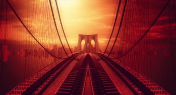 Movie still from “You Hurt My Feelings” (2023), directed by Nicole Holofcener – A view of a train track with a bridge in the background; Extreme Wide shot, High angle