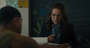 Movie still from “You Hurt My Feelings” (2023), directed by Nicole Holofcener – A woman in glasses is looking at a paper; Medium shot, Over the shoulder angle