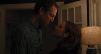 Movie still from “You Hurt My Feelings” (2023), directed by Nicole Holofcener – A man and a woman face to face in a dark room; Medium shot, Low angle