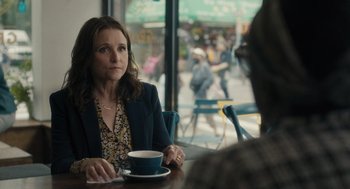 Movie still from “You Hurt My Feelings” (2023), directed by Nicole Holofcener – A woman sitting at a table in front of a man; Medium shot, Over the shoulder angle