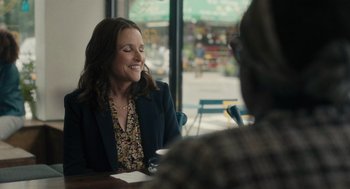 Movie still from “You Hurt My Feelings” (2023), directed by Nicole Holofcener – A woman sitting in front of a man at a table; Medium shot, Over the shoulder angle