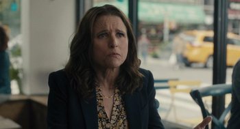 Movie still from “You Hurt My Feelings” (2023), directed by Nicole Holofcener – A woman with long brown hair wearing a black jacket; Close Up shot, Over the shoulder angle