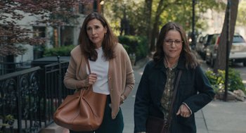 Movie still from “You Hurt My Feelings” (2023), directed by Nicole Holofcener – Two women walking down a sidewalk with a brown purse; Medium shot, Over the shoulder angle