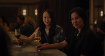 Movie still from “You Hurt My Feelings” (2023), directed by Nicole Holofcener – Two women sitting at a table with a glass of white wine; Medium shot, Over the shoulder angle