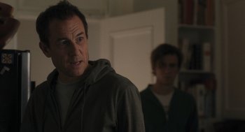 Movie still from “You Hurt My Feelings” (2023), directed by Nicole Holofcener – A man standing next to another man in front of a door; Close Up shot, Over the shoulder angle