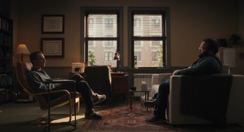 Movie still from “You Hurt My Feelings” (2023), directed by Nicole Holofcener – Two people sitting in a living room next to a window; Wide shot, Over the shoulder angle