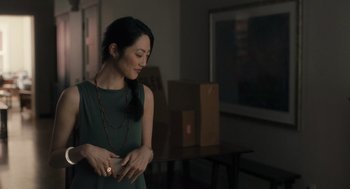 Movie still from “You Hurt My Feelings” (2023), directed by Nicole Holofcener – A beautiful woman standing in a room with her eyes closed; Medium shot, Over the shoulder angle