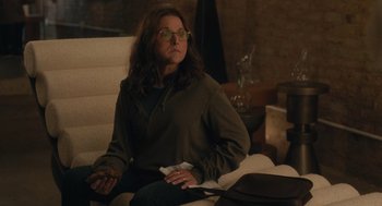 Movie still from “You Hurt My Feelings” (2023), directed by Nicole Holofcener – A woman sitting on a chair holding a paper; Medium shot, Over the shoulder angle