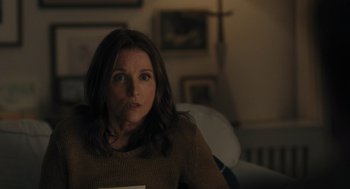 Movie still from “You Hurt My Feelings” (2023), directed by Nicole Holofcener – A woman sitting in a chair in a living room; Medium shot, Over the shoulder angle