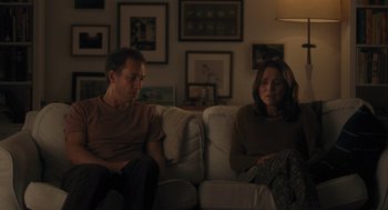 Movie still from “You Hurt My Feelings” (2023), directed by Nicole Holofcener – A man and a woman sitting on a couch in a living room; Medium shot, Over the shoulder angle