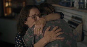 Movie still from “You Hurt My Feelings” (2023), directed by Nicole Holofcener – Two women hugging each other in a living room; Close Up shot, Over the shoulder angle