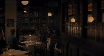 Movie still from “You Hurt My Feelings” (2023), directed by Nicole Holofcener – People are sitting at a table in a restaurant; Wide shot, Over the shoulder angle