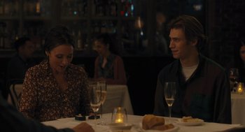 Movie still from “You Hurt My Feelings” (2023), directed by Nicole Holofcener – A man and a woman sitting at a dinner table; Medium shot, Over the shoulder angle