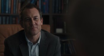Movie still from “You Hurt My Feelings” (2023), directed by Nicole Holofcener – A person wearing a suit and tie; Close Up shot, Over the shoulder angle