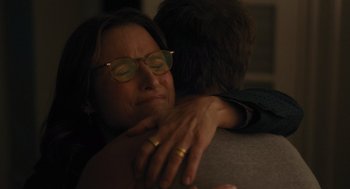 Movie still from “You Hurt My Feelings” (2023), directed by Nicole Holofcener – An older woman wearing glasses is hugging a younger man; Close Up shot, Over the shoulder angle