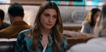 Movie still from “You People” (2023), directed by Kenya Barris – A beautiful young lady sitting at a table in a restaurant; Close Up shot, Over the shoulder angle