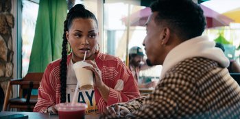 Movie still from “You People” (2023), directed by Kenya Barris – A man and a woman sitting at a table; Close Up shot, Over the shoulder angle