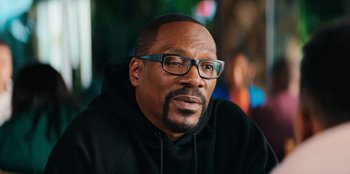 Movie still from “You People” (2023), directed by Kenya Barris – A person wearing glasses and a hoodie; Close Up shot, Over the shoulder angle