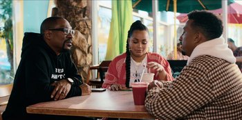 Movie still from “You People” (2023), directed by Kenya Barris – A group of people sitting around a table; Medium shot, Over the shoulder angle