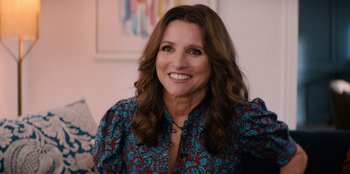 Movie still from “You People” (2023), directed by Kenya Barris – A person smiling for the camera; Close Up shot, Over the shoulder angle