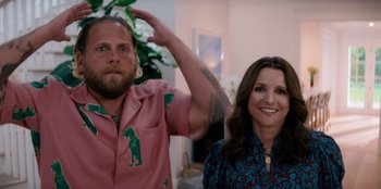 Movie still from “You People” (2023), directed by Kenya Barris – A man and a woman standing next to each other in a room; Medium shot, Over the shoulder angle