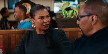 Movie still from “You People” (2023), directed by Kenya Barris – A woman sitting next to a man at a table; Close Up shot, Over the shoulder angle