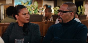 Movie still from “You People” (2023), directed by Kenya Barris – A man and a woman sitting at a table in a restaurant; Close Up shot, Over the shoulder angle