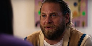 Movie still from “You People” (2023), directed by Kenya Barris – A person with long hair and a beard; Close Up shot, Over the shoulder angle