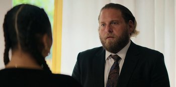 Movie still from “You People” (2023), directed by Kenya Barris – A man in a suit talking to a woman in a suit; Close Up shot, Over the shoulder angle
