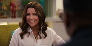 Movie still from “You People” (2023), directed by Kenya Barris – A woman in a white shirt smiling at the camera; Close Up shot, Over the shoulder angle