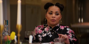 Movie still from “You People” (2023), directed by Kenya Barris – A woman sitting at a table with a glass of red wine; Close Up shot, Over the shoulder angle