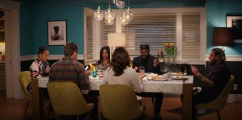 Movie still from “You People” (2023), directed by Kenya Barris – A group of people sitting around a table eating; Wide shot, High angle