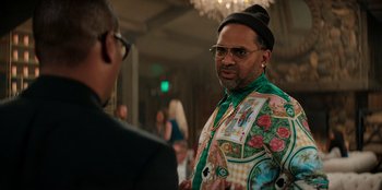 Movie still from “You People” (2023), directed by Kenya Barris – A man wearing a colorful shirt talking to a man in a black hat; Medium shot, Over the shoulder angle
