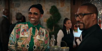 Movie still from “You People” (2023), directed by Kenya Barris – A man sitting at a table in front of a woman; Medium shot, Over the shoulder angle