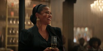 Movie still from “You People” (2023), directed by Kenya Barris – A woman holding a glass of wine in her hand; Close Up shot, Over the shoulder angle